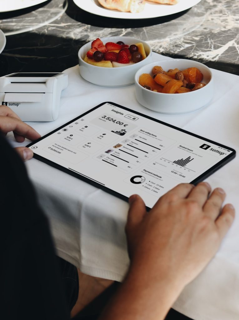 A person sitting at a table with a tablet